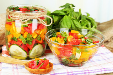 Vegetable salad in glass jar and bowl