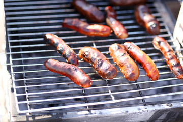 Sausages on barbecue grill, close-up