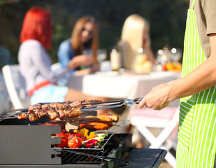 Young friends having barbecue party, outdoors