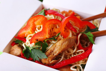 Chinese noodles in takeaway box closeup