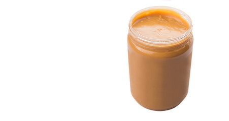 Peanut butter in a jar over white background