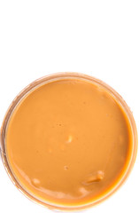 Peanut butter in a jar over white background