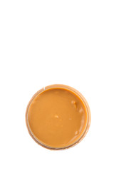 Peanut butter in a jar over white background