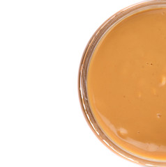 Peanut butter in a jar over white background