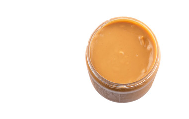 Peanut butter in a jar over white background