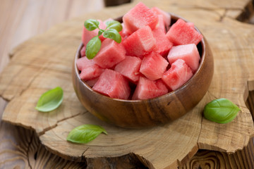 Wooden bowl with watermelon cubes, horizontal shot