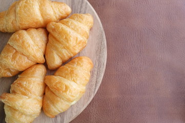Croissants on wood and  leather background
