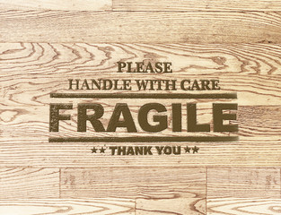 fragile word stamp on wood plank background