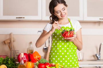 Young Woman Cooking in the kitchen. Healthy Food. Dieting Concep