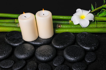 Obraz na płótnie Canvas spa concept of zen basalt stones, white flower frangipani, candl