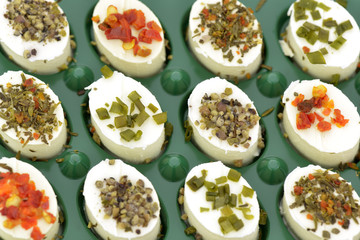 Close-up of cheese appetizers decorated  on green