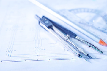 Compass and ruler lie on the drawing