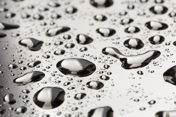 abstract water drops on polished stainless steel surface