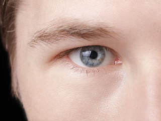 Fototapeta na wymiar face of young adult man with blue eyes