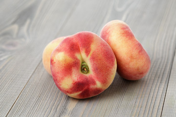 flat peaches on wood table