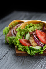pair of fresh juicy wrap sandwiches with chicken and vegetables