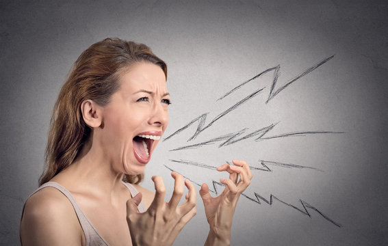 Portrait angry woman screaming isolated on grey background 