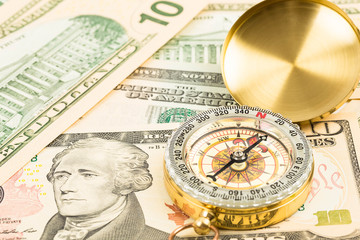 Compass on dollar banknote concept financial direction