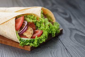 pair of fresh juicy wrap sandwiches with chicken and vegetables