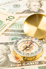 Compass on dollar banknote concept financial direction