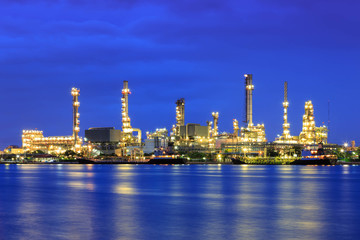 Oil refinery at twilight with reflection