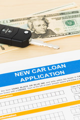 Car loan application with car key and dollar banknote