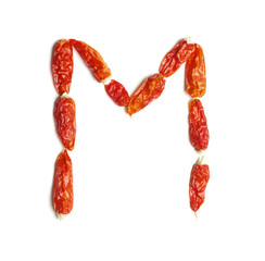 Alphabet letter M arranged from chili peppers isolated