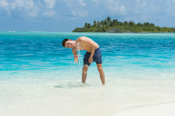 Man splash water of the ocean