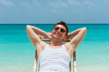 Smiling man relaxing on beach