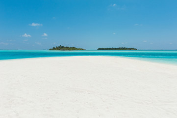 Two islands in the ocean, beach with white sand and blue water
