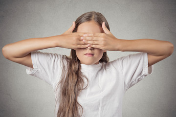 teenager girl covering eyes with hands can't see grey background