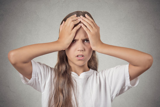 Headshot stressed child, teenager girl on grey background 