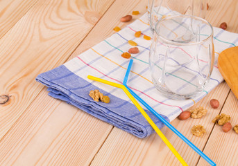 Glasses and drinking straws on tablecloth.