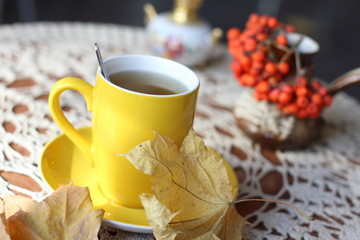 Autumn (fall) cup of tea and colorful leaves . Selective focus