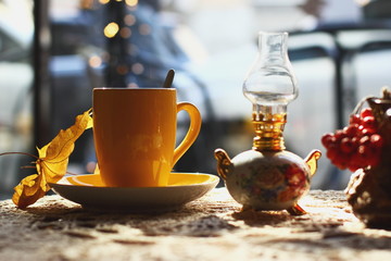 Autumn (fall) cup of tea and colorful leaves . Selective focus