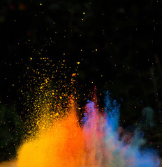 Launched colorful powder, isolated on black background