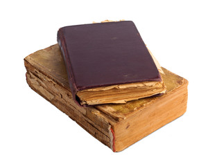A stack of old books with gold stamping on a white background is