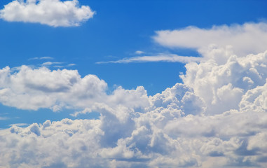 Naklejka na ściany i meble Cloudscape in sunlight with blue sky