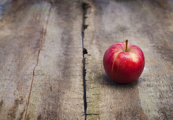 ripe red apple on wooden background horizontal