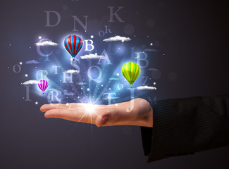 Letters and balloons in the hand of a businessman