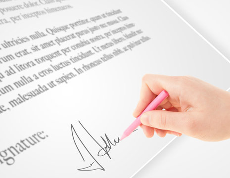 Hand writing personal signature on a paper form