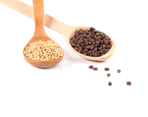 Wooden spoons full with pine nuts.