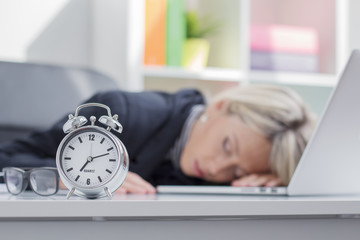 Exhausted woman sleeping in front of computer