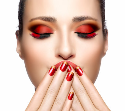 Beautiful Girl in Red with Hands on Her Face. Nail Art and Makeu
