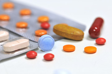 colorful medical therapy with different tablets, and pills