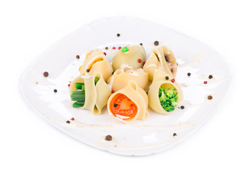 Pasta shells stuffed with vegetables and sausage.