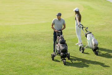 Fototapeta na wymiar Young couple playing golf
