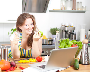 Frau mit Laptop in der Küche 