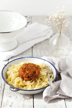 handmade pasta with ragout sauce on vintage plate