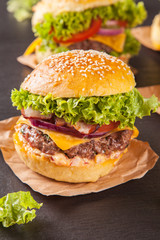 Fresh hamburgers served on black stone